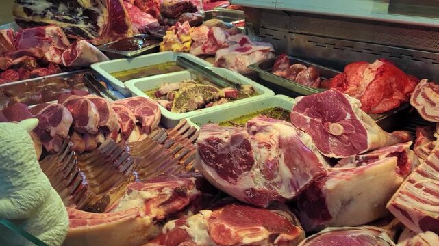 Wide Pan Left of a Meat Display at a Butcher's Shop