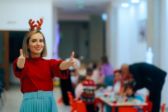 Happy Christmas Event Host Holding Thumbs up Feeling Cheerful. Event organizer feeling positive greetings guests 