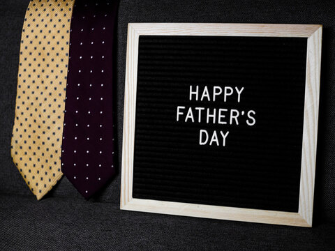 Happy Father's day with black background and yellow tie