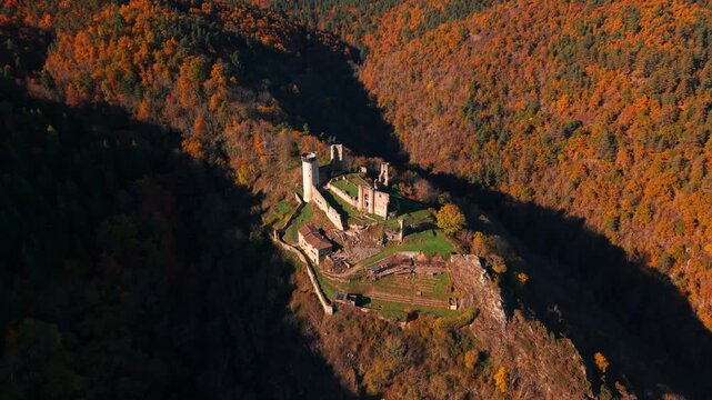 Aerial shot around the medieval castle of Rochebaron in Bas en Basset during fall season, Haute Loire departement, Auvergne Rhone Alpes season, France