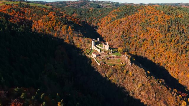 Aerial shot around the Rochebaron Castle in Bas en Basset during fall season, Haute Loire departement, Auvergne Rhone Alpes departement, France