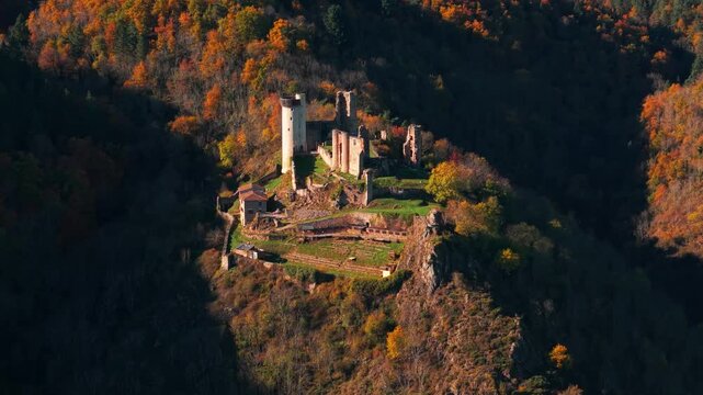 aerial shot zoomed on the Rochebaron Castle near Bas en Basset during fall season, Haute Loire departement, Auvergne Rhone Alpes region, France