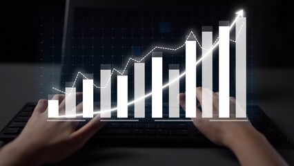 This image showcases a pair of hands typing on a keyboard with a dynamic business graph displayed on screen, symbolizing growth and data-driven success. Copula