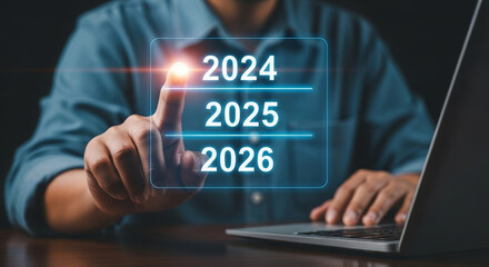 2026 business year end christmas new year planning futuristic touchscreen with person selecting 2025 for strategy and goal setting