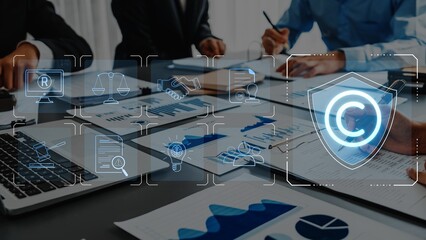 A professional business meeting scene showcasing technology and copyright symbols, emphasizing...
