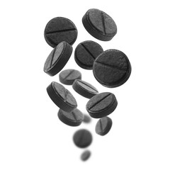 Black activated carbon tablets levitate on a white background