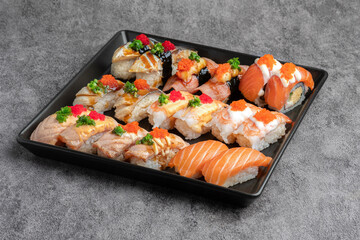 Variety of Aburi and Nigiri Sushi Platter on Dark Plate