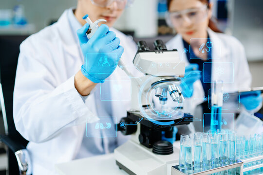 scientists in lab coats conducting research, handling glassware, and working with chemicals in a modern, high tech laboratory.
