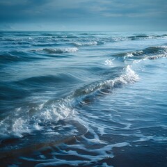 Fototapeta premium Stunning high resolution seascape of delicate ocean waves curling and gliding across the sea surface with reflective light and graceful rhythm conveying peace and movement waves on the beach