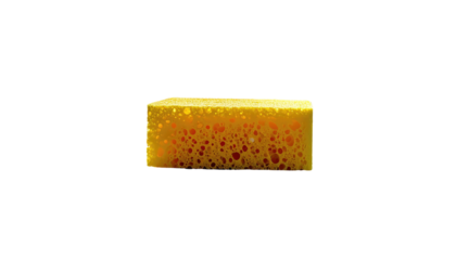 A porous, rectangular, bright yellow cleaning sponge with visible red interior, set against a stark black backdrop