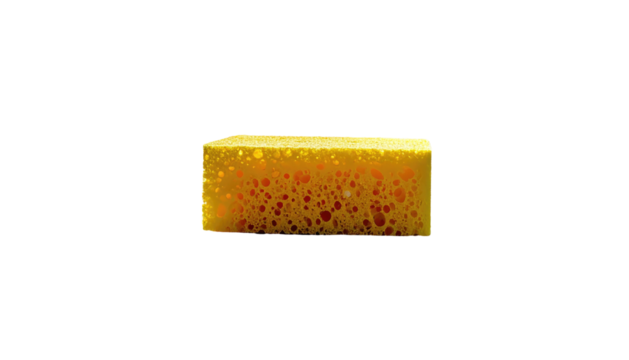 A porous, rectangular, bright yellow cleaning sponge with visible red interior, set against a stark black backdrop