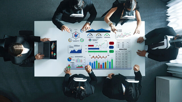 Business professionals use virtual reality headsets to analyze data in a modern office. The collaborative environment fosters innovation and strategic insights in teamwork. Trope