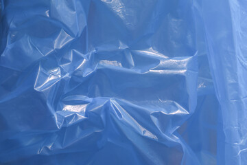 Serene blue plastic sheet background with an abstract texture. This material surface pattern reflects light, creating calm and cool visual for variety of projects