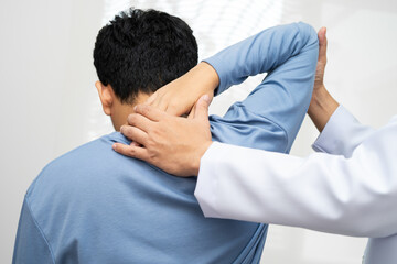Physical therapy, Asian therapist doctor treat perform pain young man in hospital.
