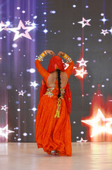 Portrait of an unidentified female artist performing classical dance in ethnic indian clothes.