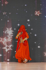 Portrait of an unidentified female artist performing classical dance in ethnic indian clothes.