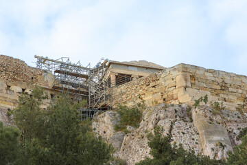 Fototapeta premium Ancient marble ruins of the Acropolis in Athens, Greece. Historic temple remains surrounded by greenery. Archaeology and classical heritage concept