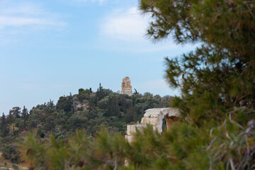 Fototapeta premium Ancient marble ruins of the Acropolis in Athens, Greece. Historic temple remains surrounded by greenery. Archaeology and classical heritage concept
