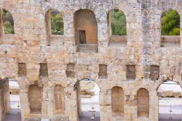 Fototapeta premium Ancient stone arches of the Odeon of Herodes Atticus, amphitheater on the Acropolis of Athens, Greece. Historic monument of music, art, and culture