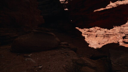 Unique rock formations and shadows create a stunning scene in a hidden canyon. Warm sunlight filters through the rocky landscape, showcasing natures artistry at dusk.