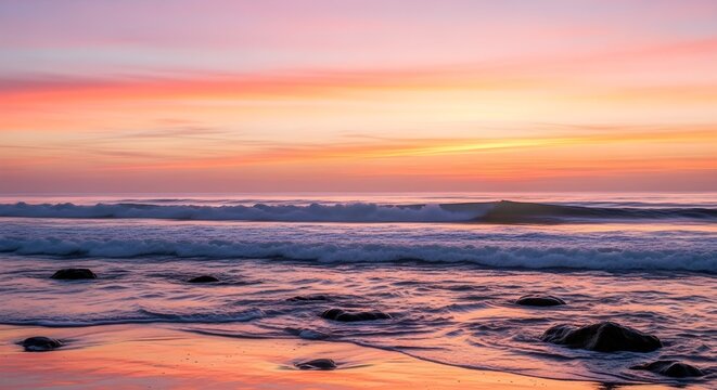 Vibrant sunset over a rocky beach with gentle waves