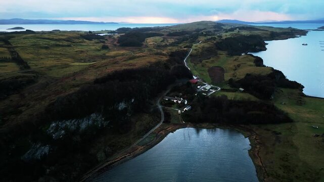 Aerial Drone Footage of a Seaside Bothy on a Scottish Loch, Isle of Lismore &mdash; Remote Stone Shelter, Rugged Coastline, Calm Water Reflections, and Dramatic Highlands Landscape in Soft Natural Light