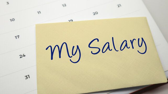 Envelope with My Salary written in blue ink placed on a calendar background