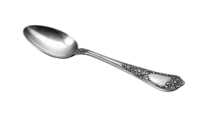Ornate silver spoon, highly polished, on a black background. Lies diagonally, handle intricately decorated, bowl reflects light