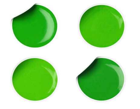 Four green stickers with peeled edges on black