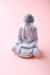 Meditating Buddha Statue on bright background. Soft focus. Copy space	