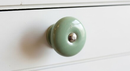 Elegant Round Green Ceramic Drawer Knob on White Cabinet Surface Close-Up