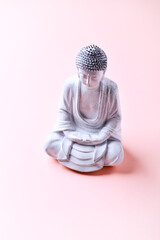 Meditating Buddha Statue on bright background. Soft focus. Copy space	