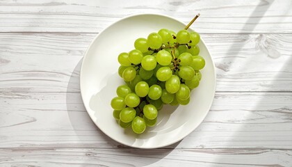 Fresh Green Grapes on a White Plate With Natural Sunlight and Shadow Patterns on a White Wooden Table Surface