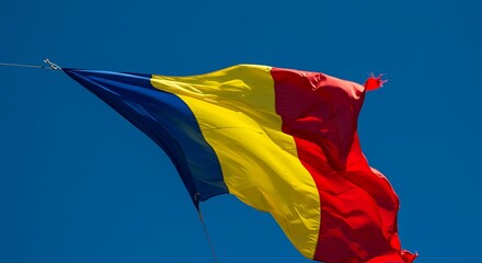 Romanian flag waving proudly against a clear blue sky, symbolizing national pride and a bright future on a sunny day, evoking a sense of patriotism.