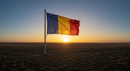 Romanian flag waving gently in the wind at sunrise over a vast, open field, symbolizing national pride and a new beginning.
