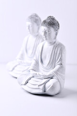 Meditating Buddha Statue on bright background. Soft focus. Copy space	