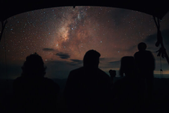 Night camping on the mountain under the night sky and milky way with friends. Travel and hiking concept. - Powered by Adobe