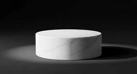 Cylindrical marble podium on a dark shadowed surface