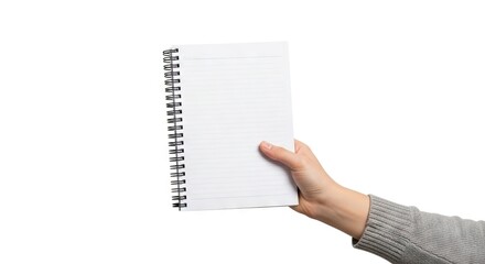 Hand holds open lined notebook with spiral binding gray sweater sleeve visible