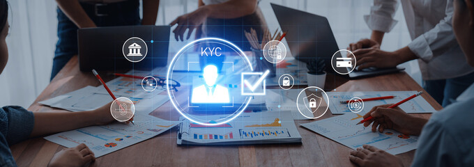A team of professionals engages in a strategic meeting focused on KYC processes, utilizing technology and data analytics to enhance compliance and security measures in business. Trope