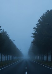 A foggy morning road surrounded by trees with soft natural blur and muted tones, evoking calm and mystery.