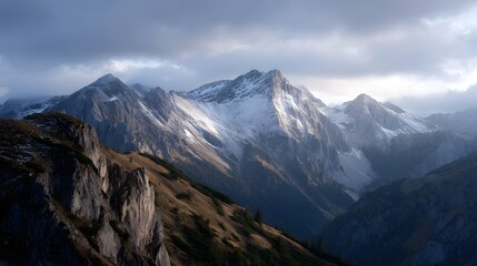 Dramatic alpine ridge with snow capped peaks under a moody twilight sky