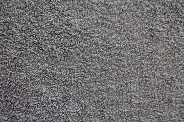 Gray textured fabric surface with soft loops and plush detail