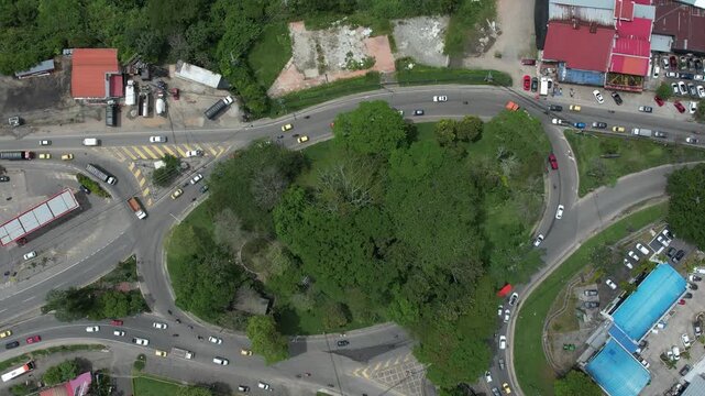 Aerial drone shot showing vehicle flow through Mirolindo roundabout in Ibagu&eacute;, Tolima, Colombia on a clear day.