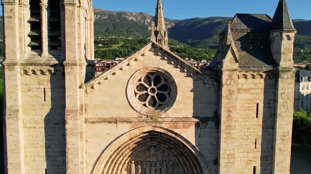 Stone church facade with mountainous backdrop