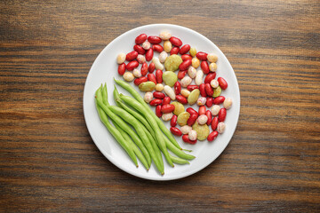 Fresh green beans and colorful beans on white plate