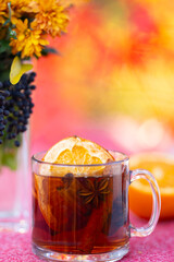 Autumn fall decor with mulled wine, books, cookies and flowers. Cozy fall. Autumnal mood. Fresh pastries and hot tea invite relaxation. Comfort and calm autumn. Cozy autumnal vibes.