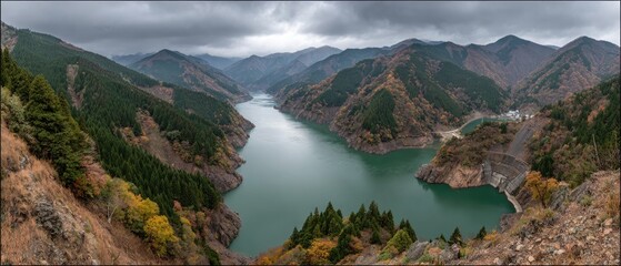 Panoramic view of a mountain lake with a dam