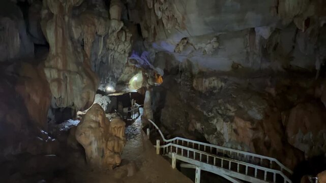Wang Vieng, Laos.Tham Jang Cave-stalactites and stalagmites in a karst mountain with a Buddha temple inside. There is a spring inside the cave. The cave is equipped with comfortable paths and lanterns