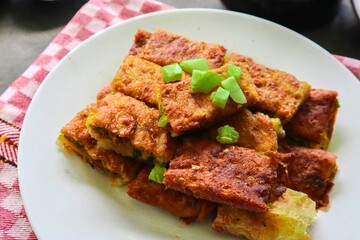 Crispy fried tofu rectangles garnished with green onions
